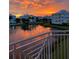 Balcony view of a pond reflecting the sunset sky and community buildings at 3418 79Th Street W Cir # 202, Bradenton, FL 34209