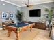 Pool table in an entertainment room with ceiling fan, TV, and coastal decor at 3418 79Th Street W Cir # 202, Bradenton, FL 34209