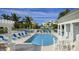Outdoor swimming pool with ample seating and well-maintained landscaping in complex at 3418 79Th Street W Cir # 202, Bradenton, FL 34209