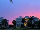 Buildings at dusk with a vibrant pink and purple sunset and palm trees at 3418 79Th Street W Cir # 202, Bradenton, FL 34209