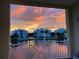 Balcony view of the sunset reflected off the community pond water and buildings at 3418 79Th Street W Cir # 202, Bradenton, FL 34209