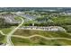 Expansive aerial view of a community featuring single-Gathering homes, a lake, and green spaces at 3553 Secluded Ct, Sarasota, FL 34240