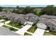An aerial view displays a house in a well-planned community with tree-lined streets and manicured lawns at 3553 Secluded Ct, Sarasota, FL 34240
