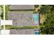 An aerial shot of a home with a screened-in pool, surrounded by lush greenery and neighboring houses at 3553 Secluded Ct, Sarasota, FL 34240