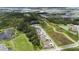An aerial shot of a neighborhood with green spaces and a lake, offering a serene and nature-filled living experience at 3553 Secluded Ct, Sarasota, FL 34240