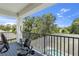 Covered porch featuring outdoor exercise equipment and views of the landscape at 3553 Secluded Ct, Sarasota, FL 34240