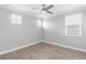 Bedroom with ceiling fan, multiple windows with blinds, and hardwood floors at 3553 Secluded Ct, Sarasota, FL 34240