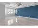 Bedroom featuring a tray ceiling, large windows, and a blue accent wall at 3553 Secluded Ct, Sarasota, FL 34240