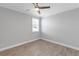 Bedroom with ceiling fan, window with blinds, and hardwood floors at 3553 Secluded Ct, Sarasota, FL 34240