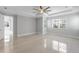 Bright bedroom with tray ceiling, large windows, and neutral color scheme at 3553 Secluded Ct, Sarasota, FL 34240