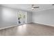 Open bedroom with hardwood floors, gray walls, and a ceiling fan at 3553 Secluded Ct, Sarasota, FL 34240
