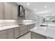 Modern kitchen featuring quartz countertops, stainless steel appliances, designer backsplash, and an expansive island at 3553 Secluded Ct, Sarasota, FL 34240