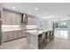 Open concept kitchen with stainless steel appliances, quartz counters, ample seating, and a view of the pool at 3553 Secluded Ct, Sarasota, FL 34240