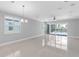 Open-concept living room with tile flooring and sliding glass doors to the pool at 3553 Secluded Ct, Sarasota, FL 34240
