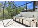 Outdoor kitchen with grill and stainless steel appliances inside screened lanai at 3553 Secluded Ct, Sarasota, FL 34240