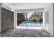 Outdoor space with brick pavers leading to a screened pool enclosure at 3553 Secluded Ct, Sarasota, FL 34240