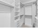 Spacious walk-in closet with custom shelving, drawers, and metal rods for optimal storage at 3553 Secluded Ct, Sarasota, FL 34240