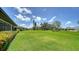 Lush green backyard with view of adjacent homes in the neighborhood at 3734 Ballantrae Dr # 19D, Sarasota, FL 34238