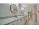 Bathroom features a double vanity with granite countertops and decorative mirrors at 3734 Ballantrae Dr # 19D, Sarasota, FL 34238