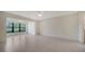 Bright bedroom featuring tile floors, a ceiling fan, and a large window at 3734 Ballantrae Dr # 19D, Sarasota, FL 34238