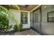Enclosed porch with tile flooring, offering a sheltered entry with natural light and decorative plants at 3734 Ballantrae Dr # 19D, Sarasota, FL 34238
