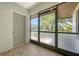 Screened-in entryway with tile floor and front door view, providing an airy transition from the outdoors at 3734 Ballantrae Dr # 19D, Sarasota, FL 34238