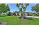 Charming single-story home featuring a well-manicured lawn and a mature tree, offering curb appeal and shade at 3734 Ballantrae Dr # 19D, Sarasota, FL 34238