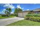 Attached two-car garage with a paved driveway, providing ample parking and convenient access to the home at 3734 Ballantrae Dr # 19D, Sarasota, FL 34238