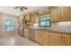 Well-lit kitchen featuring stainless steel appliances, light wood cabinets, and tile flooring at 3734 Ballantrae Dr # 19D, Sarasota, FL 34238