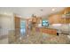 Bright kitchen features granite countertops, stainless steel appliances, and light wood cabinets at 3734 Ballantrae Dr # 19D, Sarasota, FL 34238