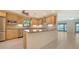 Updated kitchen with stainless steel appliances, granite countertops, and tile backsplash, showcasing modern design and functionality at 3734 Ballantrae Dr # 19D, Sarasota, FL 34238