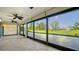 Enclosed lanai with tiled floor and ceiling fans overlooking a manicured lawn at 3734 Ballantrae Dr # 19D, Sarasota, FL 34238