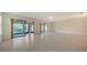 Living room boasts tile flooring, neutral walls, and sliding glass doors at 3734 Ballantrae Dr # 19D, Sarasota, FL 34238
