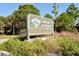 An inviting Oscar Scherer State Park entrance features lush greenery and a sign, blending nature with recreation at 3734 Ballantrae Dr # 19D, Sarasota, FL 34238