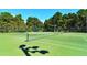 A tennis court, surrounded by trees, providing residents with a fun way to stay active and enjoy the outdoors at 3734 Ballantrae Dr # 19D, Sarasota, FL 34238