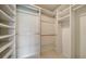 Walk-in closet featuring shelving and hanging rods at 3734 Ballantrae Dr # 19D, Sarasota, FL 34238