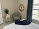 Relaxing bedroom with a chair, table and a clock on the wall at 3703 39Th Street W # 11, Bradenton, FL 34205
