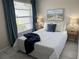 Beautifully staged bedroom with a comfy queen bed, blue accents, and ample natural light at 3703 39Th Street W # 11, Bradenton, FL 34205