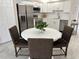 Modern kitchen with white cabinets, stainless steel appliances, and an adjacent breakfast nook at 3703 39Th Street W # 11, Bradenton, FL 34205