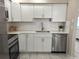Bright kitchen showcasing white cabinetry, countertops, and stainless-steel appliances at 3703 39Th Street W # 11, Bradenton, FL 34205