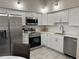 Updated kitchen featuring white cabinetry, stainless steel appliances, and sleek countertops at 3703 39Th Street W # 11, Bradenton, FL 34205