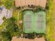 Aerial view of community tennis courts surrounded by lush landscaping and well-maintained buildings and parking at 4057 Crockers Lake Blvd # 15, Sarasota, FL 34238