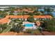 Aerial view of a community featuring lush landscaping, a swimming pool, and well-maintained buildings at 4057 Crockers Lake Blvd # 15, Sarasota, FL 34238