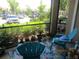 Enclosed outdoor patio with chairs and potted plants overlooking lush landscaping at 4057 Crockers Lake Blvd # 15, Sarasota, FL 34238