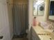 Well-lit bathroom featuring a neutral color scheme, vanity, mirror, and a shower with curtain at 4057 Crockers Lake Blvd # 15, Sarasota, FL 34238