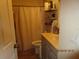 Bathroom featuring a shower with curtain, vanity, and open shelving for storage at 4057 Crockers Lake Blvd # 15, Sarasota, FL 34238
