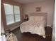 Bright bedroom with hardwood floors, a comfortable bed, and a large window for natural light at 4057 Crockers Lake Blvd # 15, Sarasota, FL 34238