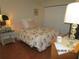 Comfortable bedroom with a floral-patterned bedspread and laminate floors for a cozy feel at 4057 Crockers Lake Blvd # 15, Sarasota, FL 34238