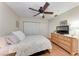 Cozy bedroom features a ceiling fan, closet and dresser, and a cozy floral bedspread at 4057 Crockers Lake Blvd # 15, Sarasota, FL 34238