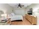 Inviting bedroom boasts a ceiling fan, closet and dresser, and a cozy floral bedspread at 4057 Crockers Lake Blvd # 15, Sarasota, FL 34238